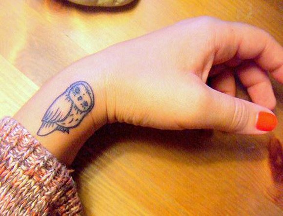 Small Cute Black Outline Barn Owl Tattoo On Wrist