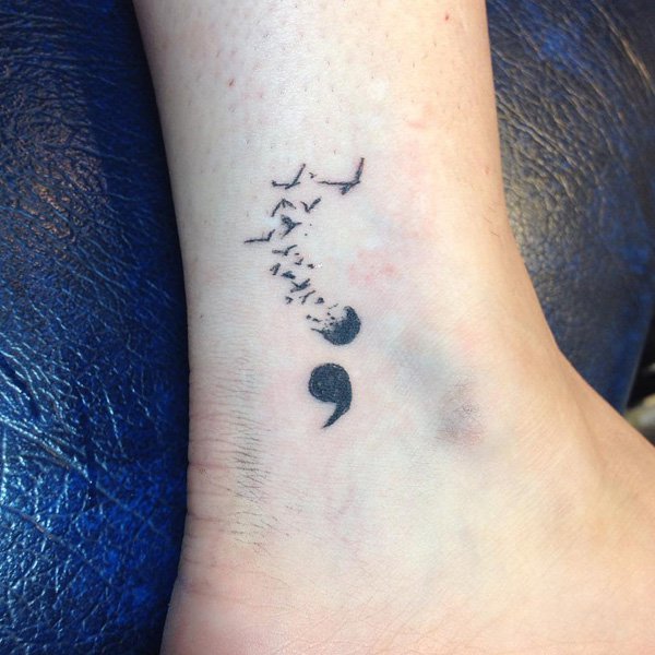 Amazing Black Ink Semicolon And Flying Birds Tattoo On Ankle