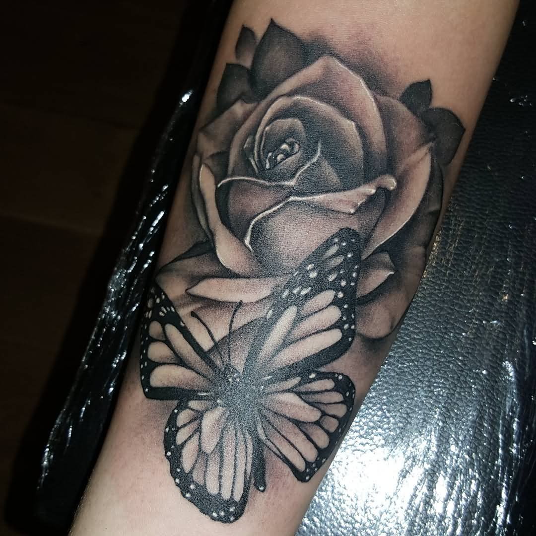 Black And Grey Rose With Butterfly Tattoo On Forearm