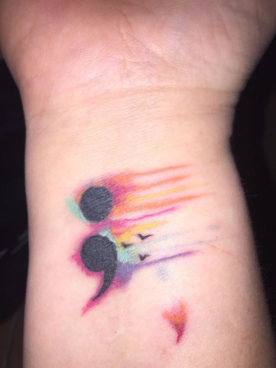 Black Flying Birds And Semicolon Tattoo With Colorful Shades On Wrist