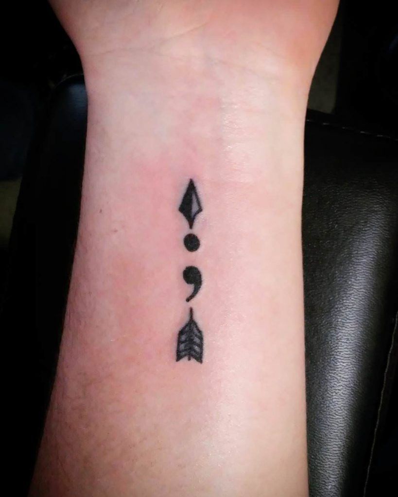 Black Ink Arrow And Semicolon Compostion Tattoo On Wrist