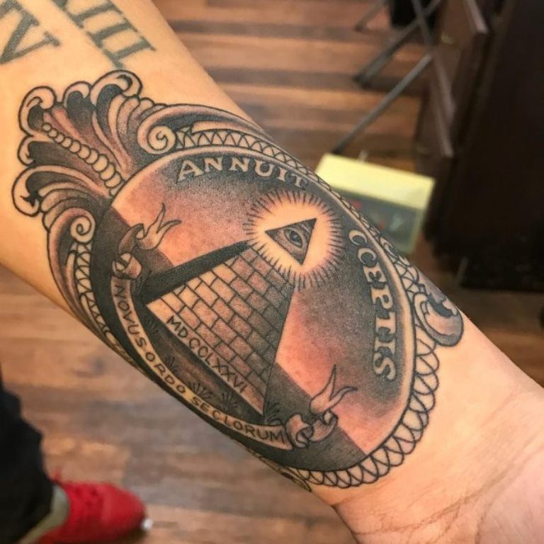 Black Ink Bright Glowing Illuminati on Pyramid Top In Antique Frame Tattoo On Male Forearm