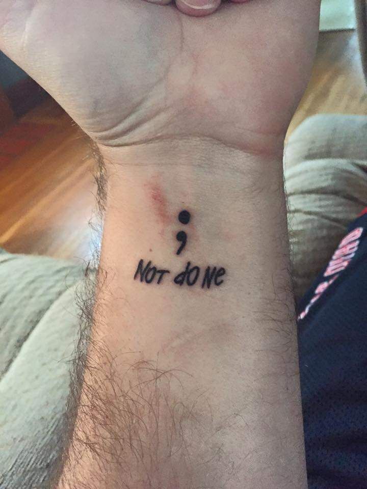 Black Semicolon With Lettering ‘Not Done’ Tattoo On Man Wrist