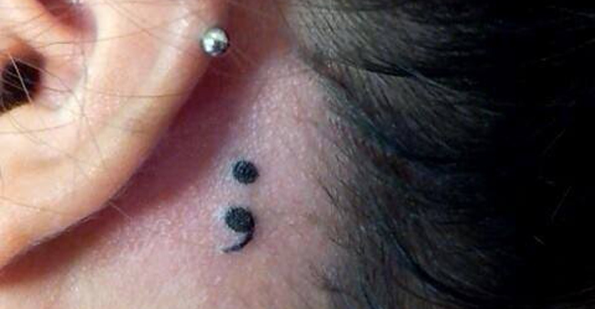 Cute Small Black Ink Semicolon Tattoo Behind The Ear For Girls