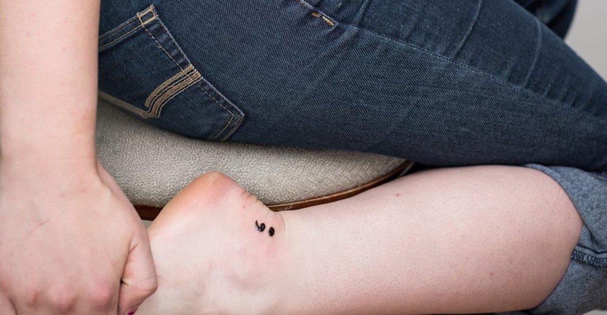 Cute Small Black Ink Semicolon Tattoo On Ankle For Girls