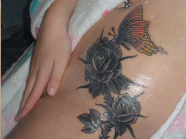 Dark Black Roses With A Colorful Butterfly Tattoo On Thigh