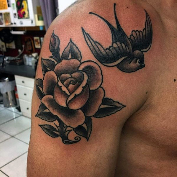 Fabulous Black Ink Swallow And Rose Tattoo On Male Shoulder