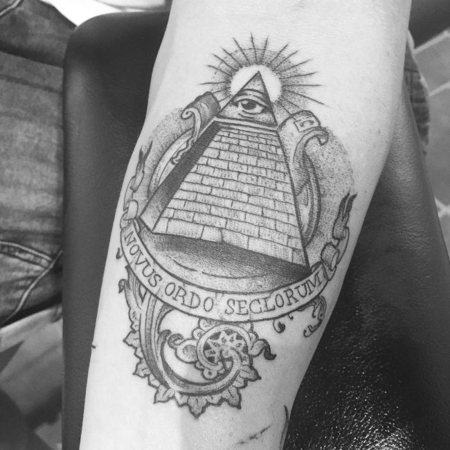 Grey Ink Illuminati On Pyramid Top Tattoo On Forearm