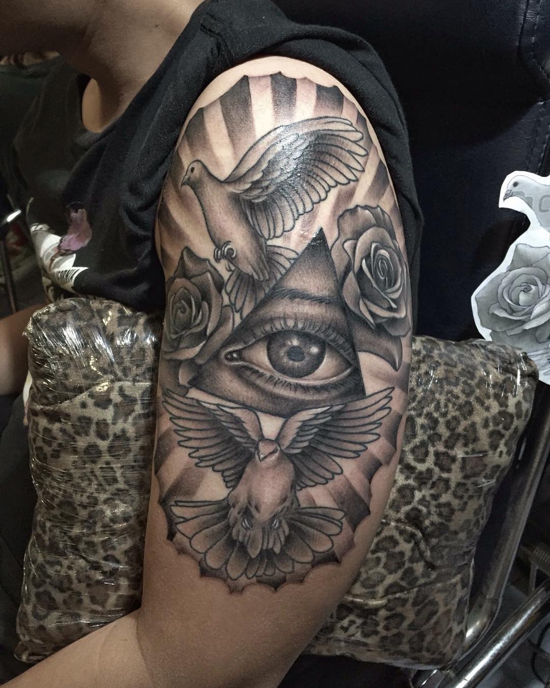 Grey Ink Illuminati With Roses & Birds Tattoo On Male Half Sleeve