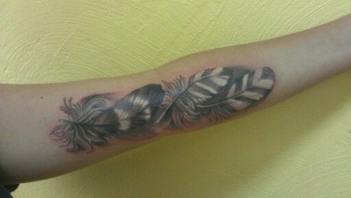 Grey Ink Owl Feather Tattoo On Inner Arm For Women