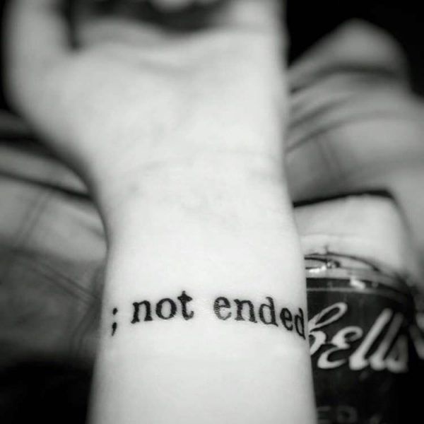 Inspirational ‘Not Ended’ And Semicolon Tattoo On Wrist