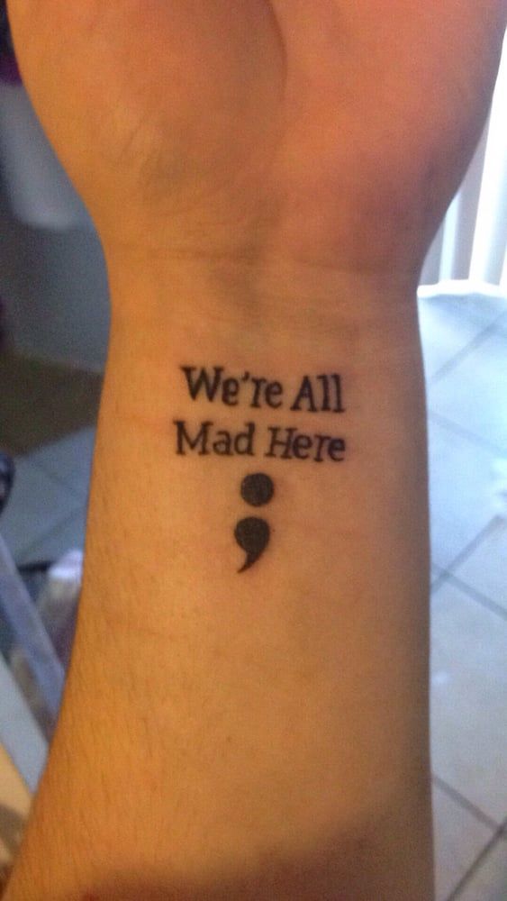 Lettering ‘We’re All Mad Here ‘& Semicolon Tattoo On Wrist
