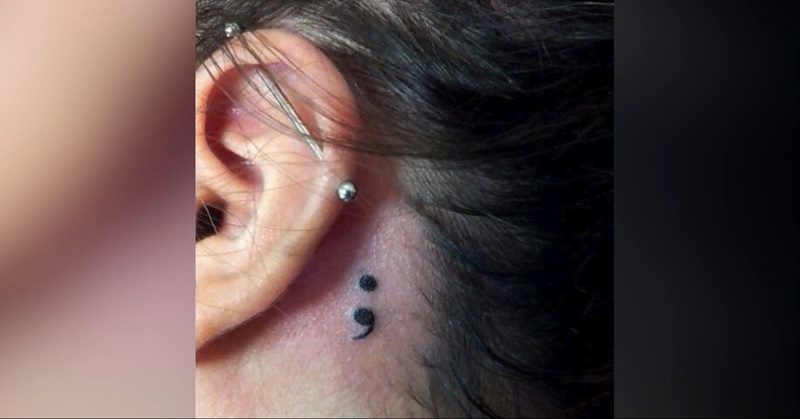 Small Black Semicolon Tattoo Behind The Ear For Women