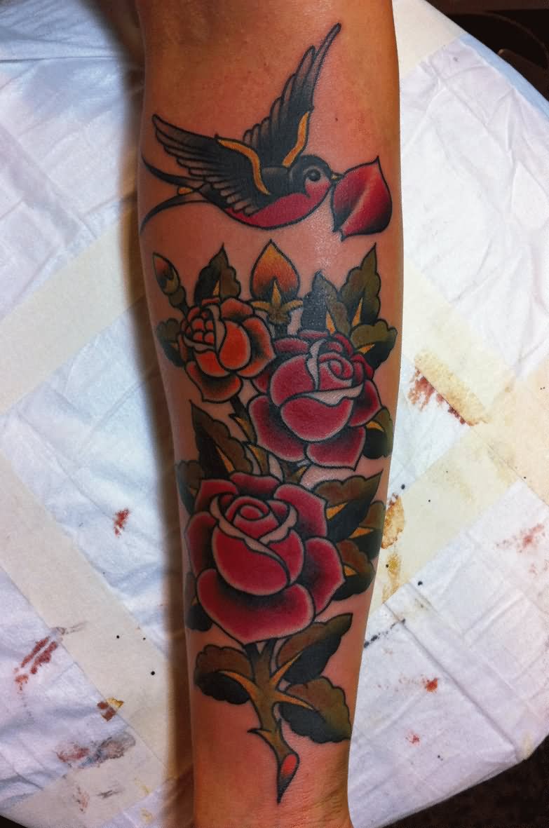 Traditional Flying Swallow With Red Roses Tattoo On Inner Forearm By mark lonsdale