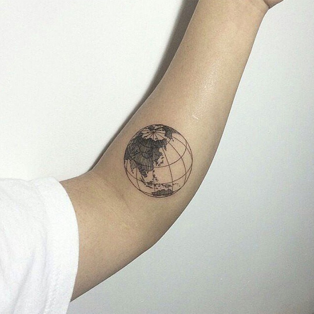 Black 3d earth globe tattoo on inner arm