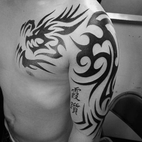 Black Chinese tribal dragon tattoo on left upper chest and half arm