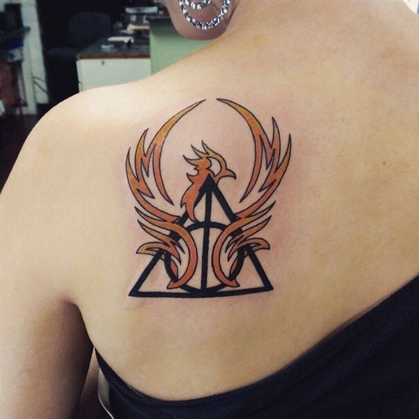 Black Deathly Hallows With Orange Phoenix Tattoo On Girl Back Shoulder