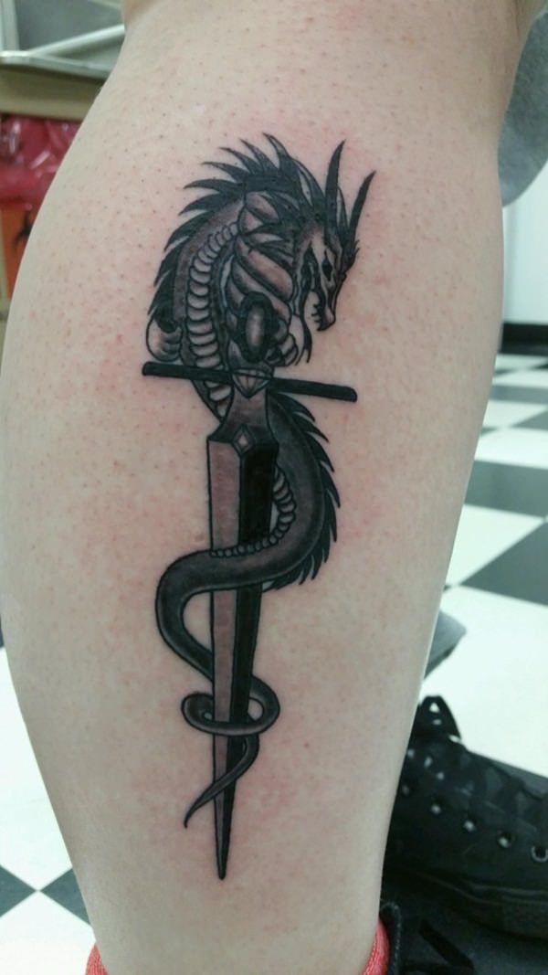 Black Ink Dagger and Gothic dragon tattoo on leg