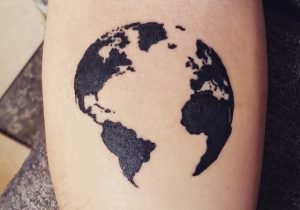 Black Ink map earth tattoo on arm