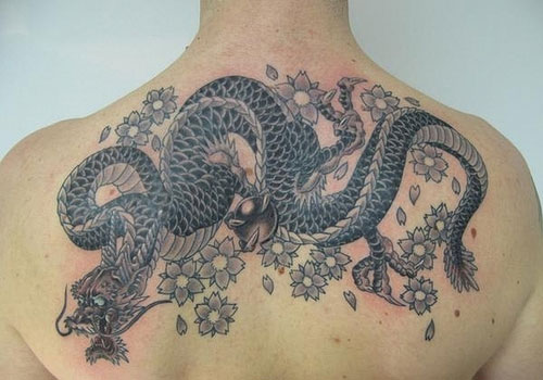 Black Traditional Dragon With Grey Flowers Tattoo On Upper Back