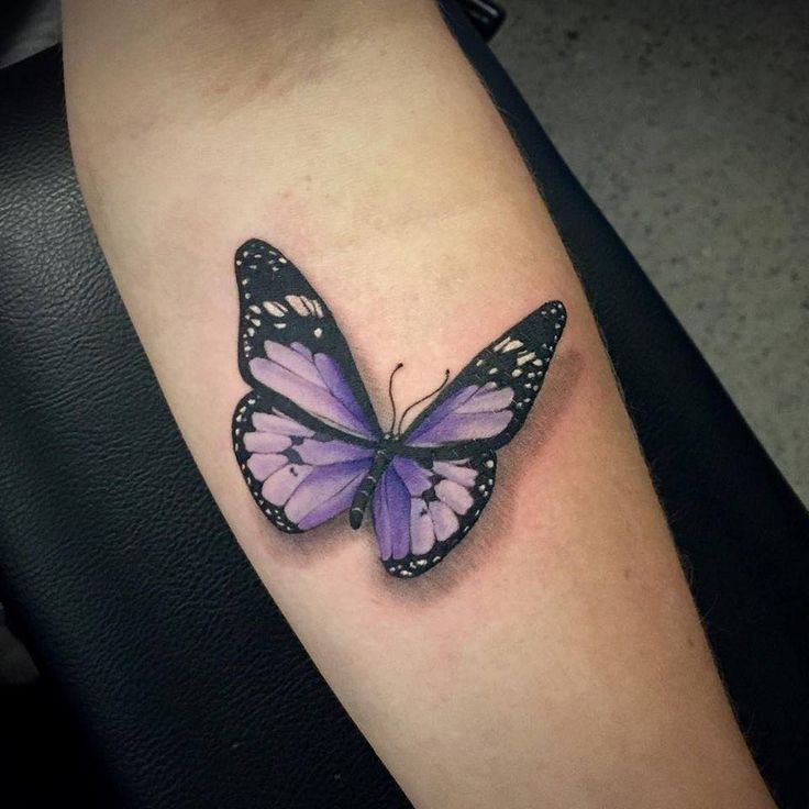 Black and Purple Butterfly tattoo on inner forearm