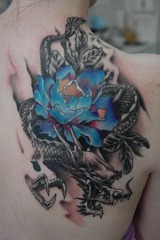 Black and blue dragon flower tattoo on upper right back for women