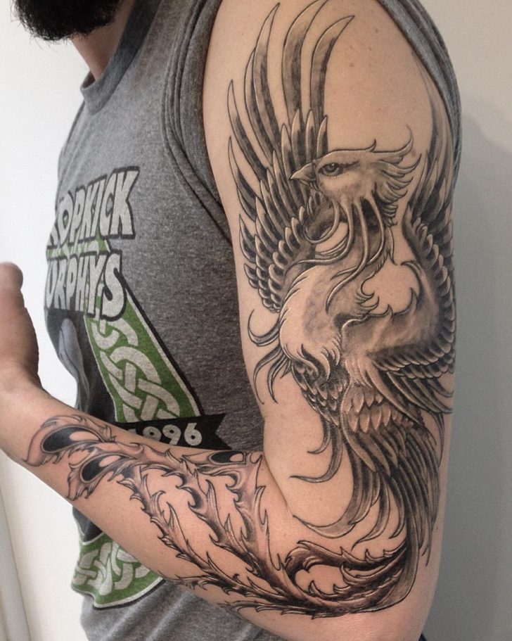 Black and gray realistic male full sleeve phoenix tattoo by Kc Faldasz
