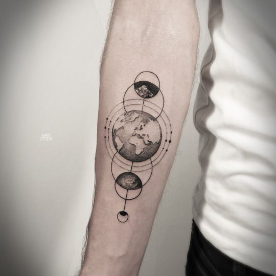 Black and white earth tattoo with planets on mid inner arm