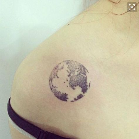 Black and white shaded earth tattoo on left front shoulder