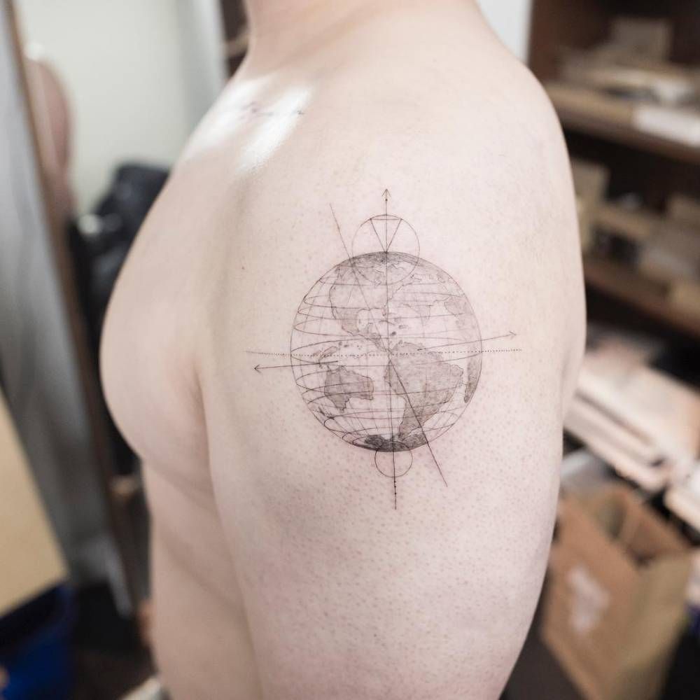 Black and white shaded earth tattoo with grid on upper left arm for men
