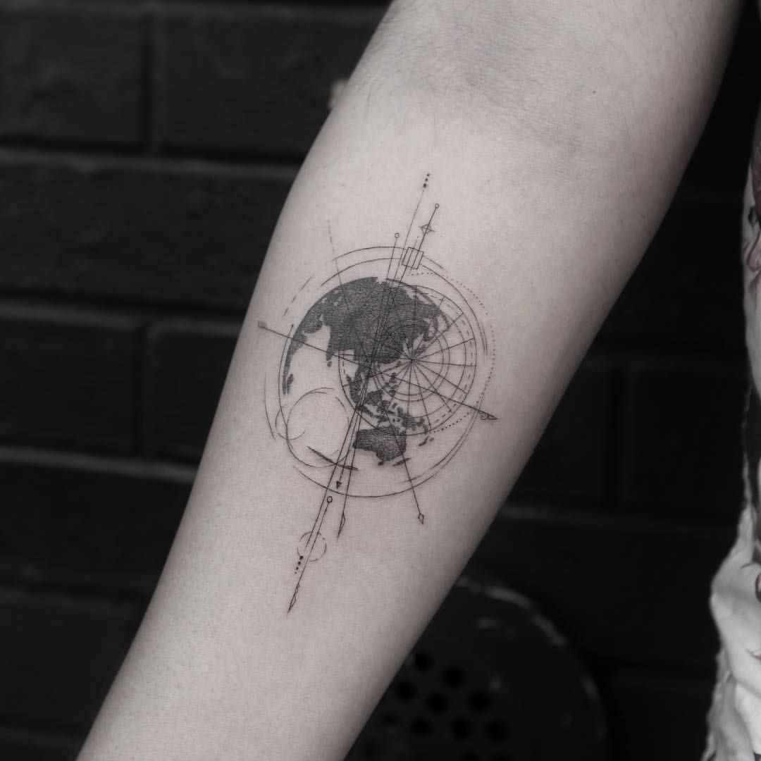 Black and white shaded geometric earth tattoo on inner mid forearm