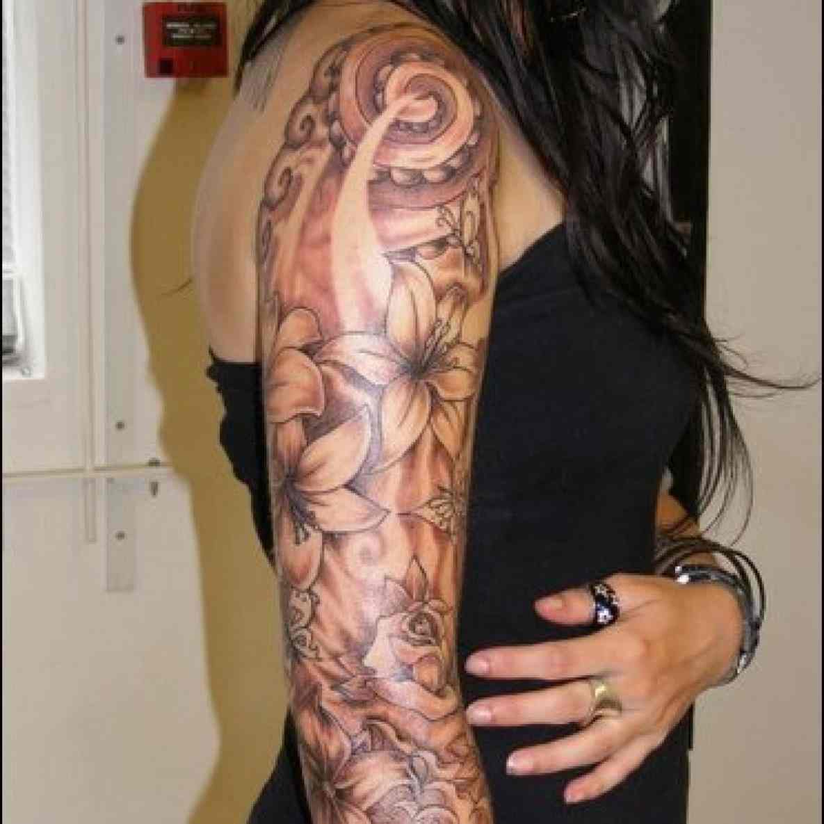 Black and grey shaded dragon flower tattoo on full sleeve