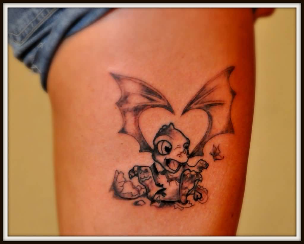 Black baby dragon tattoo on arm