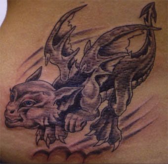Black baby dragon tattoo on body