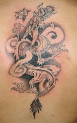 Black dragon flower tattoo on body
