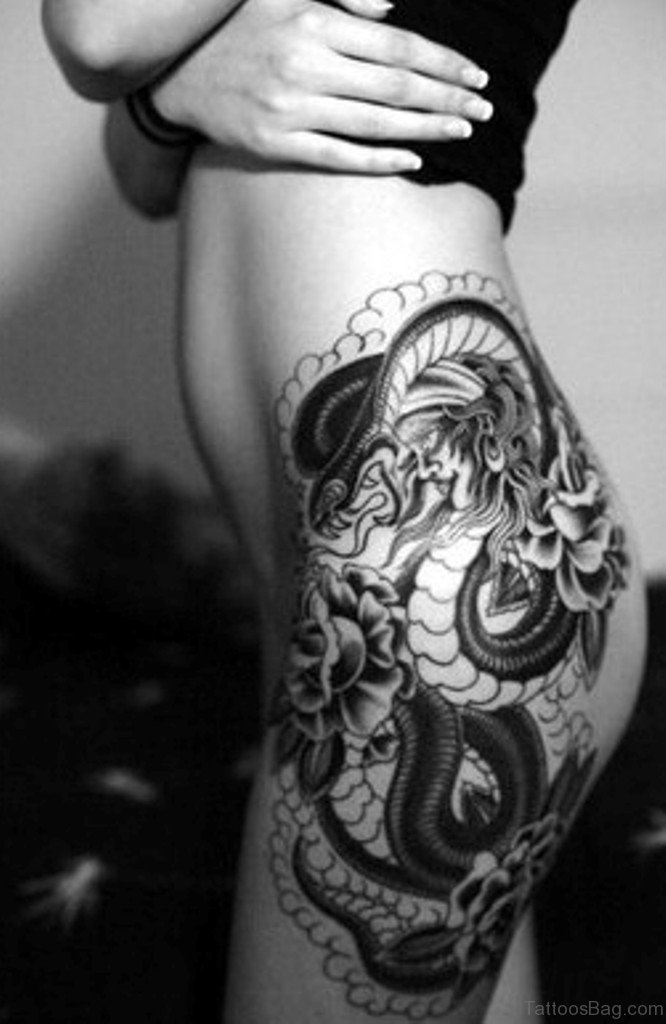 Black dragon tattoo design on left thigh
