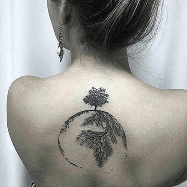 Black earth tree tattoo on upper mid back
