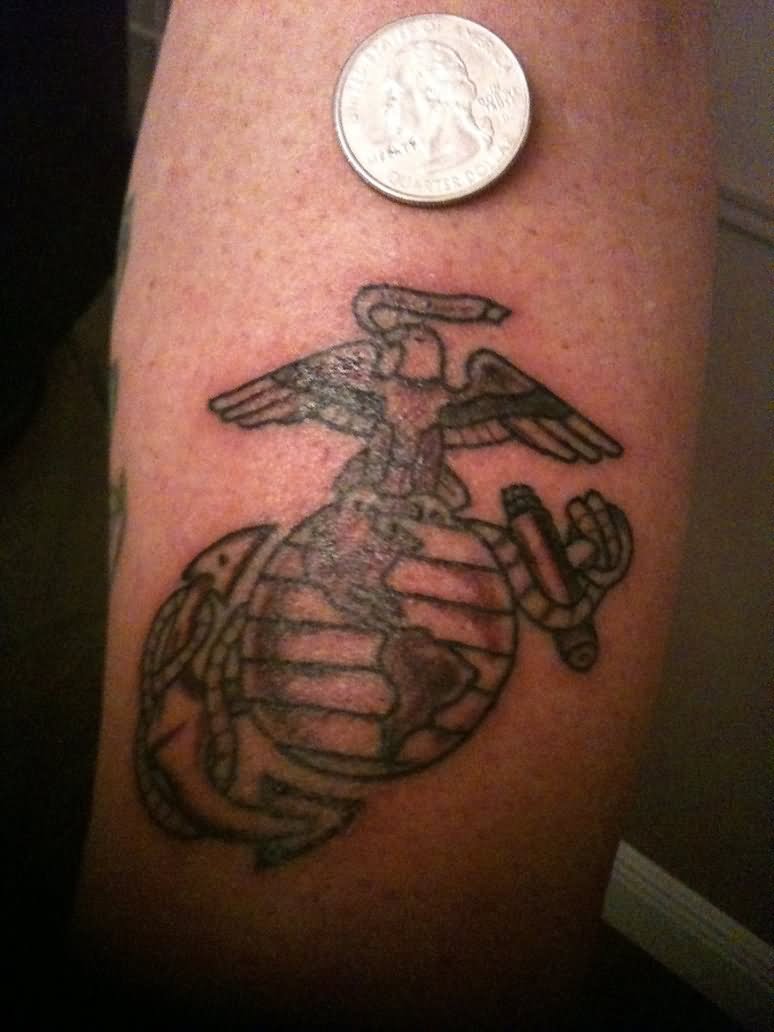 Black globe, eagle and anchor tattoo on arm