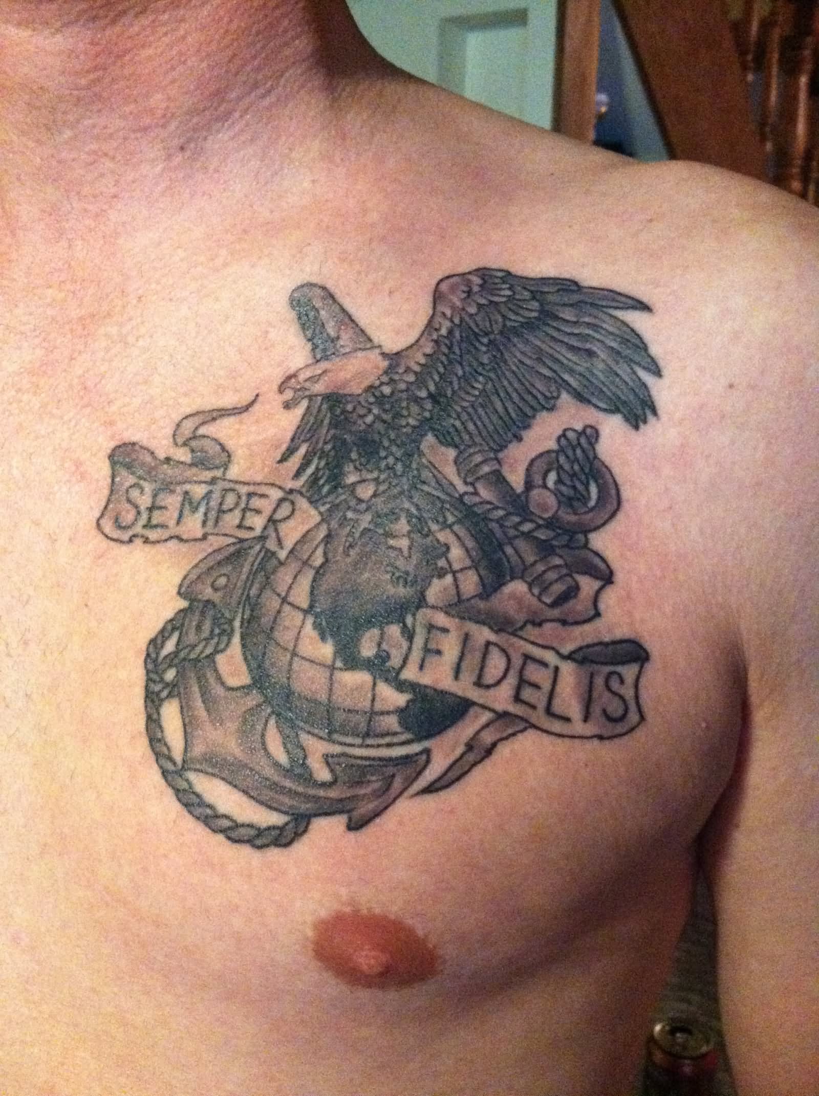 Black globe, eagle and anchor tattoo on left upper chest