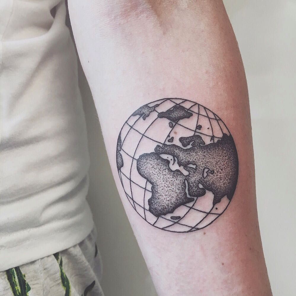 Black globe earth tattoo with grid on man inner forearm