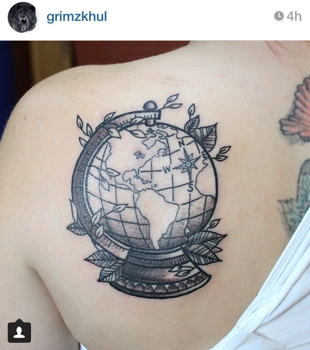 Black globe earth tattoo with leaves on upper left back