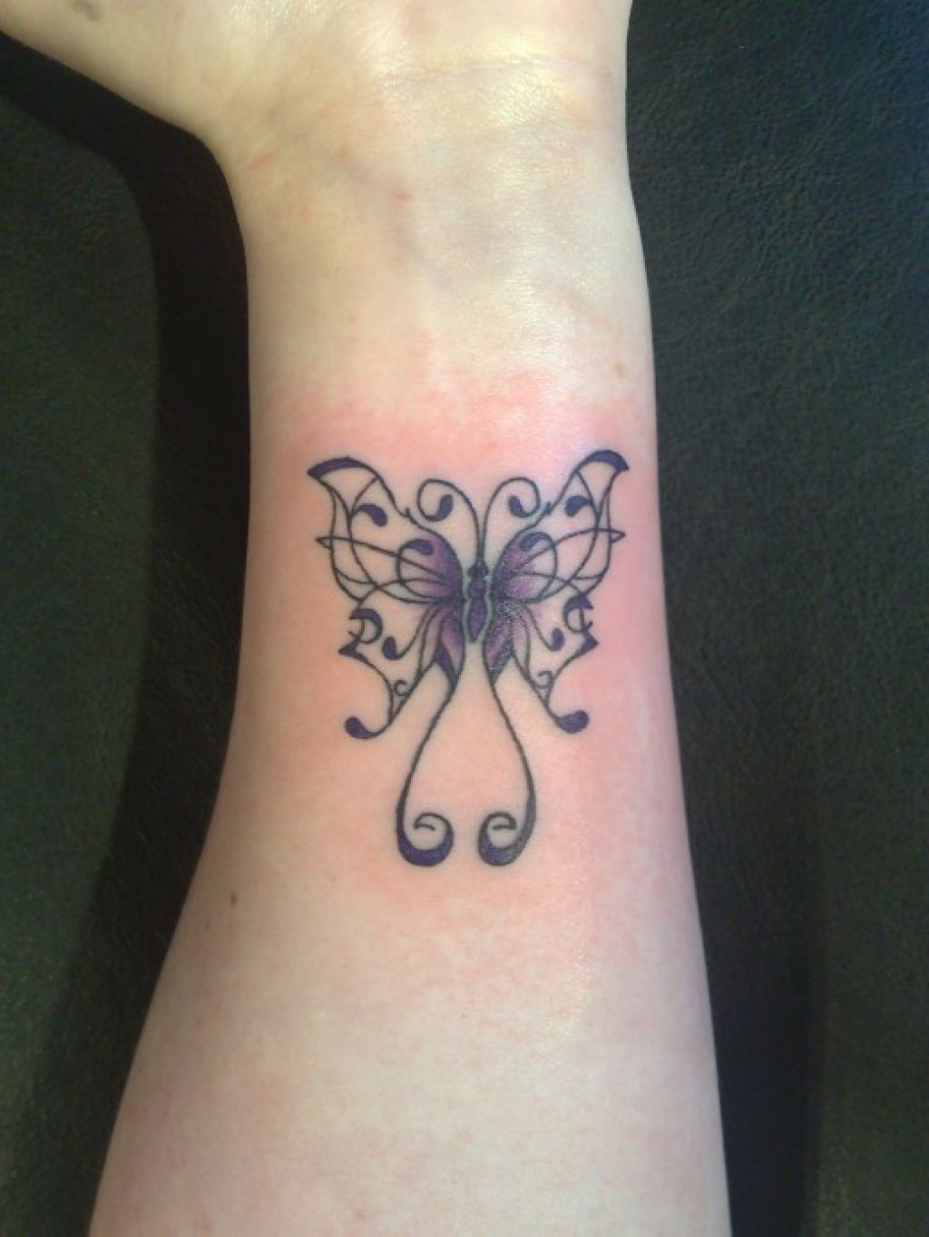 Black Gothic butterfly tattoo on wrist