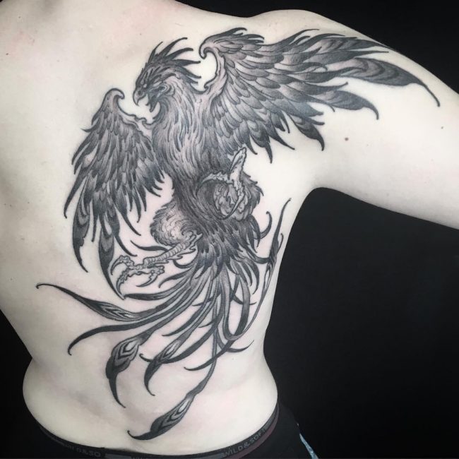 Black & grey flying phoenix male back tattoo