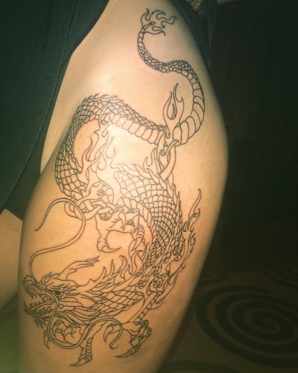Black outline dragon tattoo on thigh for girls