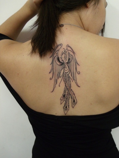 Black outline phoenix tattoo on the back