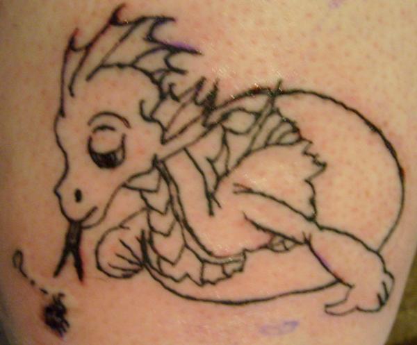 Black outlined baby dragon tattoo and egg on body