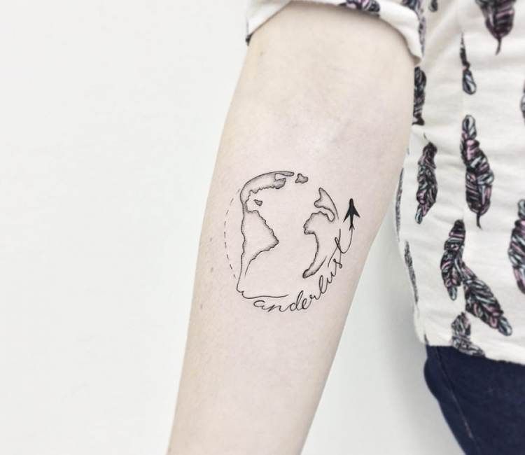 Black outlined earth with airplane tattoo on inner arm