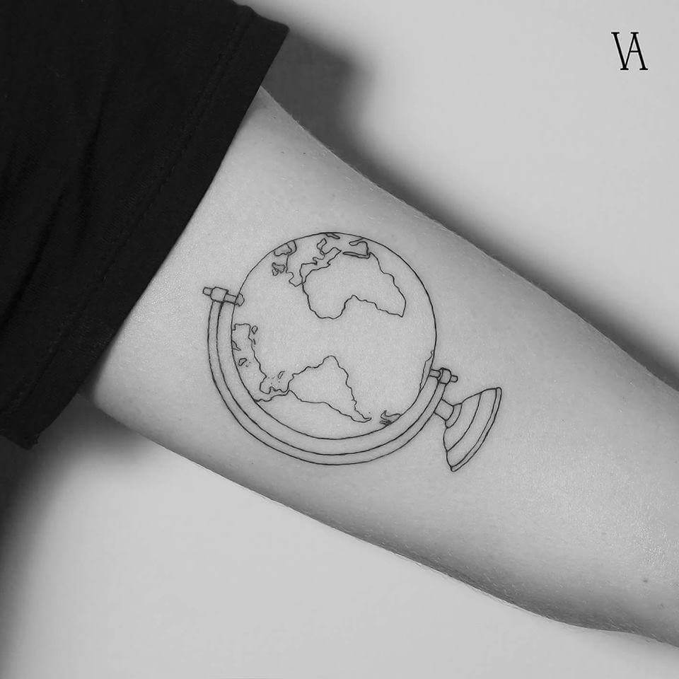 Black outlined globe earth tattoo on inner upper arm