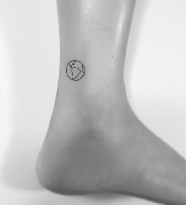 Black outlined small earth tattoo on right ankle for women