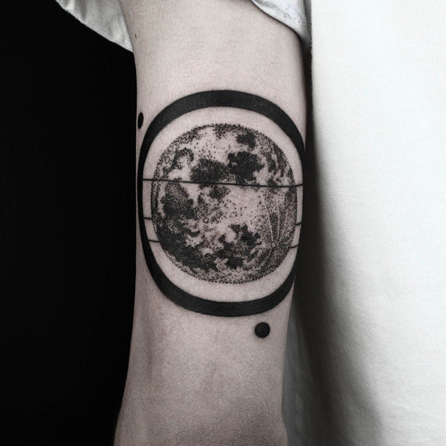 Black ring shaded earth tattoo on arm by Okanuckun